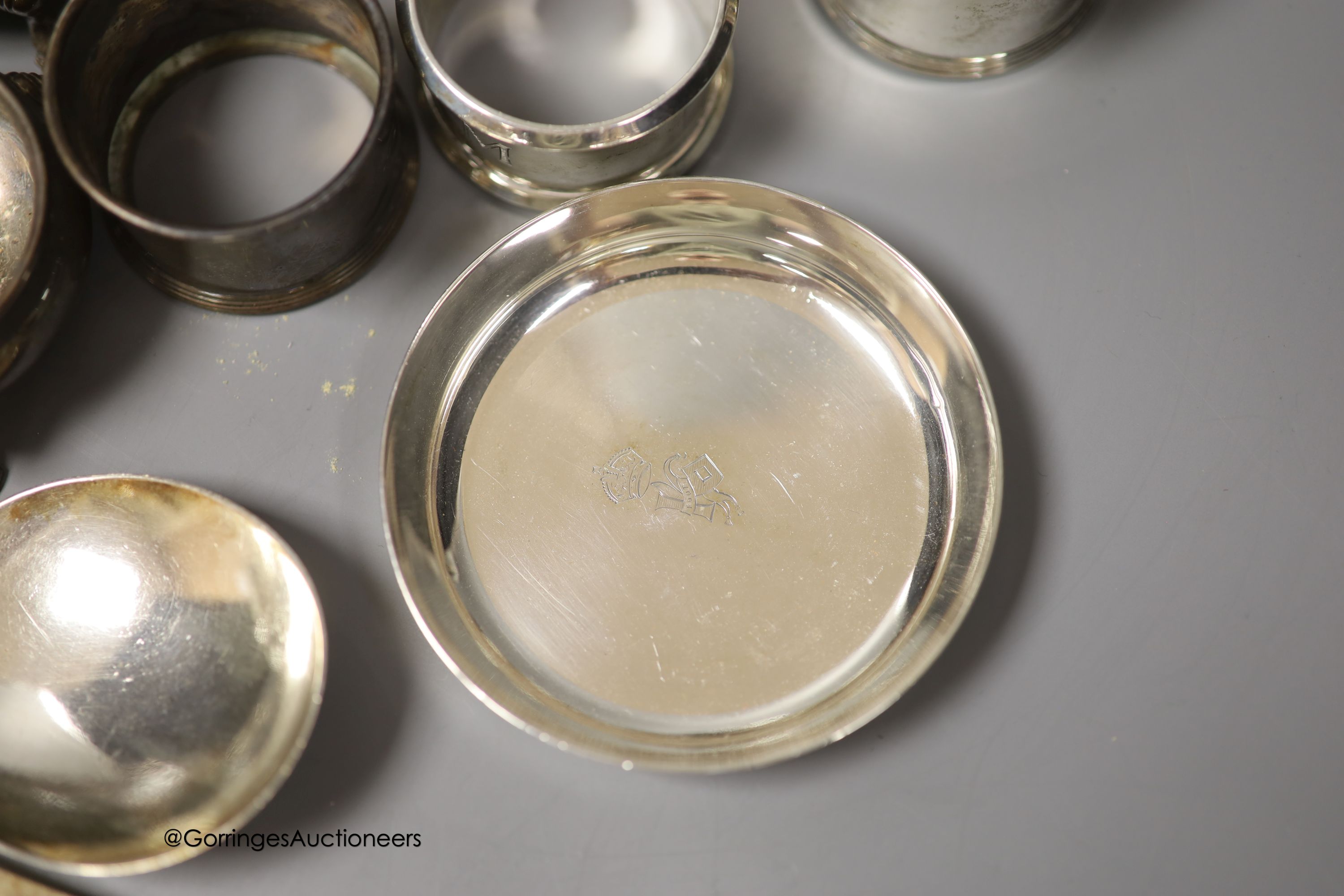 A group of minor silver including a George V trinket box, sauceboat, pair of soup spoons, pair of napkin rings, two bun salts, four small dishes, condiments etc. and three plated items.